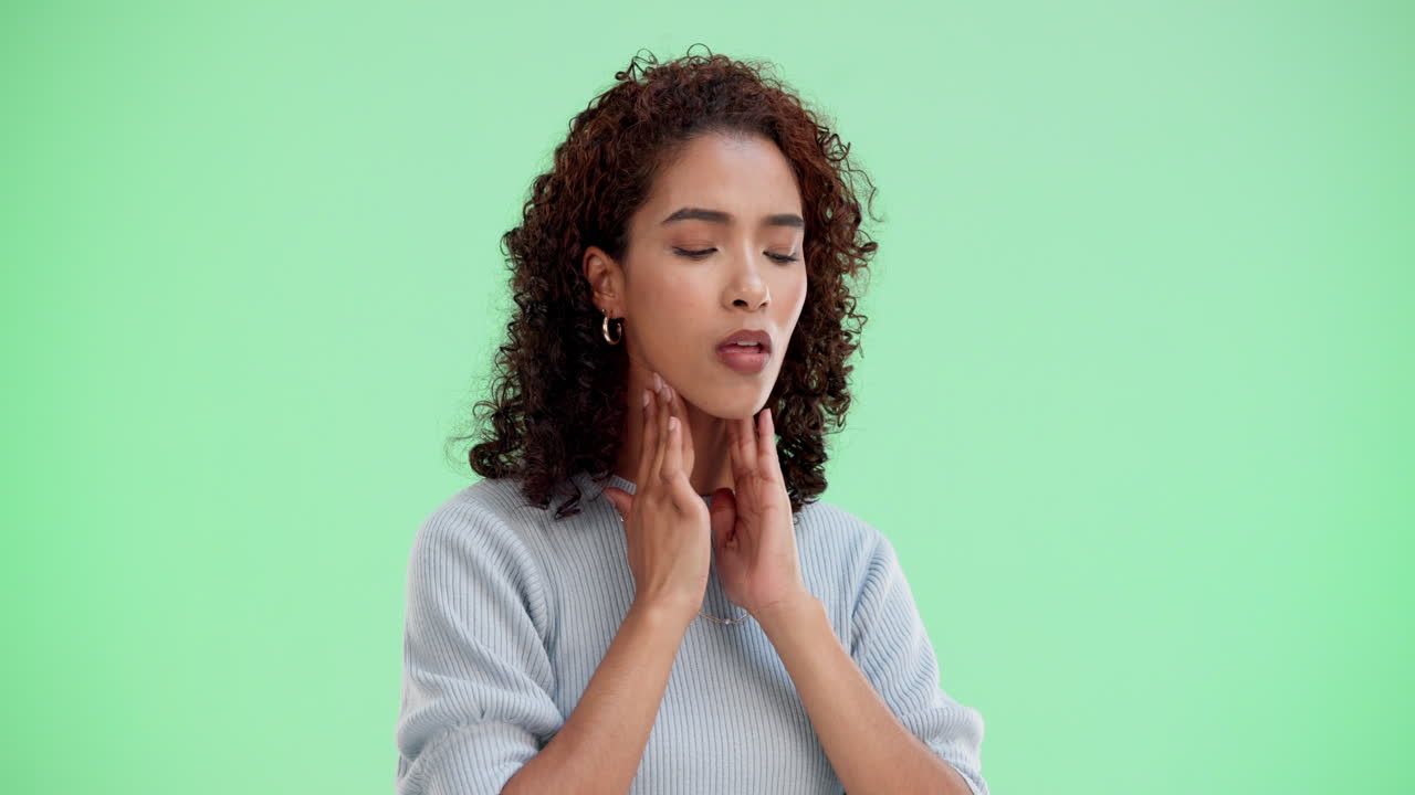 Woman with sore throat touching her neck