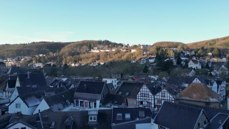 upward drone movement. sunset aerial footage with warm golden light illuminating bad münstereifel’s historic streets.