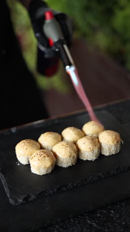 chef preparing delicious torched sushi