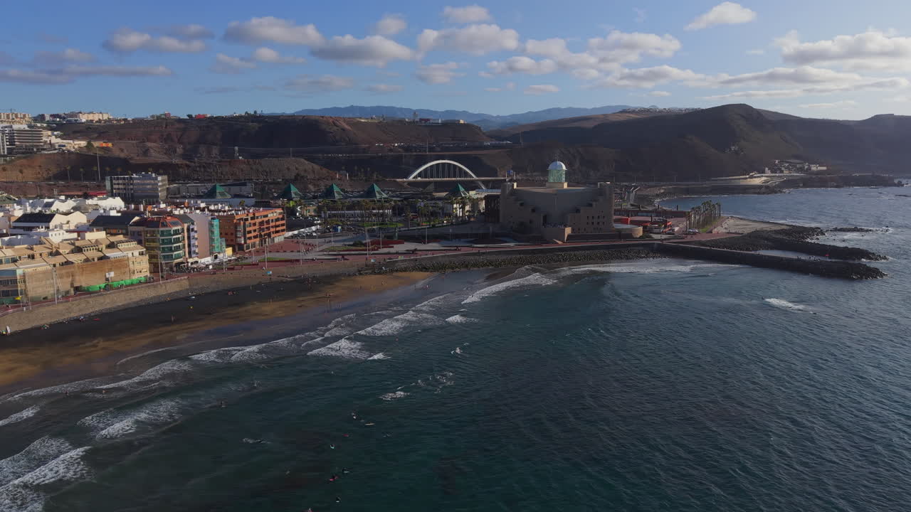 Aerial view of Las Canteras beach, Alfredo Kraus auditorium, and the city of Las Palmas de Gran Canaria at sunset
