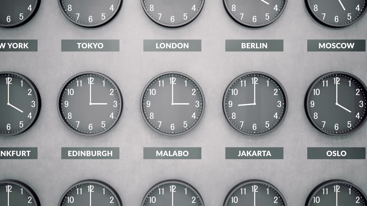 Round clocks show different time zones on a dark concrete wall. Camera moves left to right.