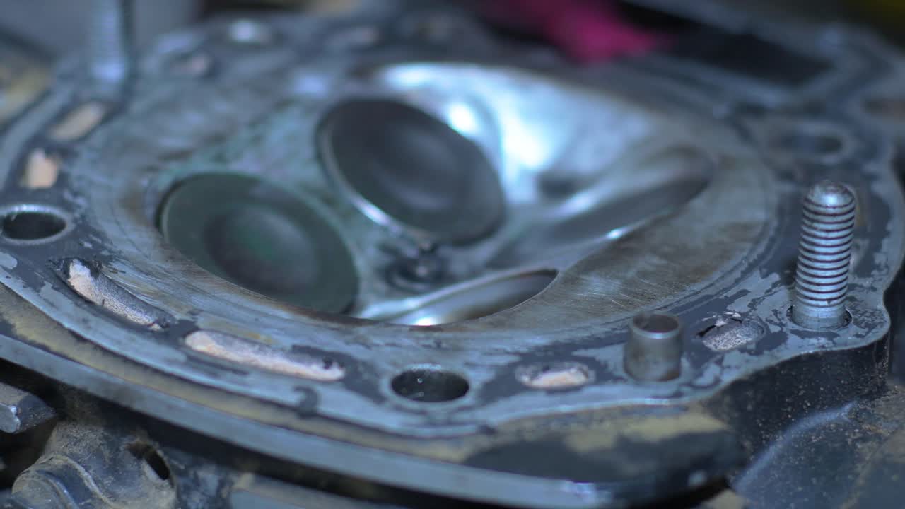 Mechanic Cleaning Engine Valves with a Cloth