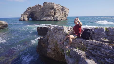 talking on cell phone in rocky beach.