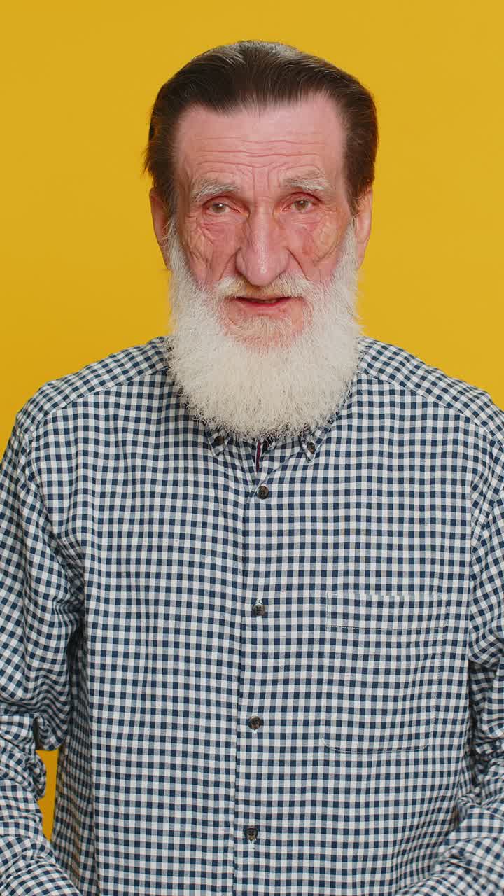 Annoyed irritated senior man covering ears gesturing no avoiding advice ignoring noise loud voices