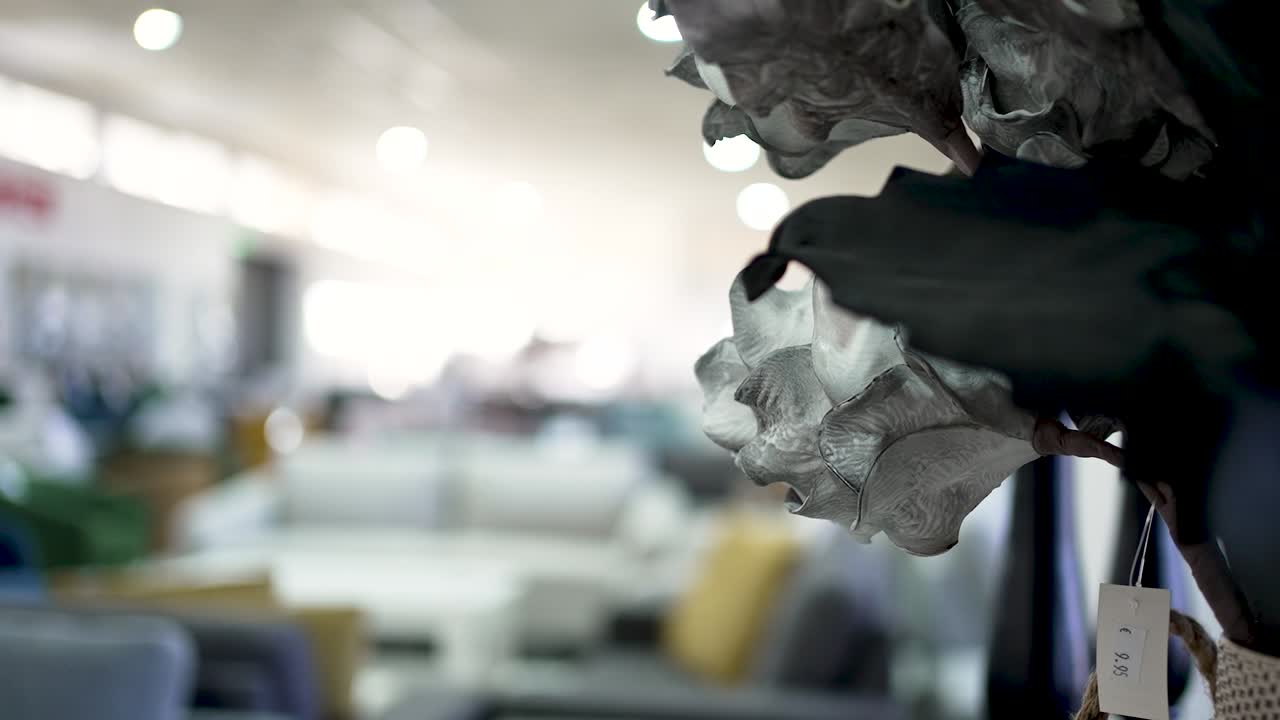 A close-up view of elegant flowers in a bright indoor environment. The soft lighting enhances the serene atmosphere and beauty of the arrangement