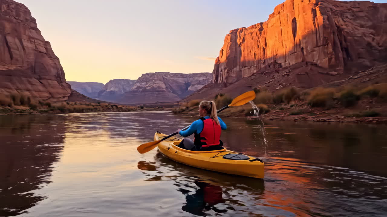 Kayaking through a scenic canyon at sunset