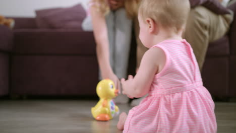 infant playing with toy on floor. sweet baby enjoy walking in room