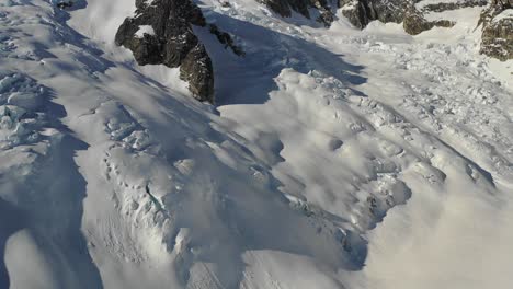 4k drone footage flying over glacier and panning up to reveal mountain