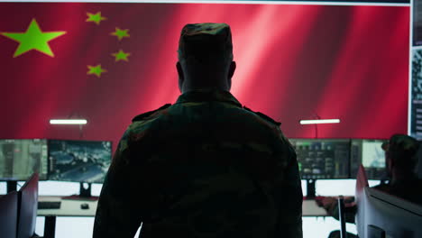 Chinese-military-officer-analyzing-information-on-big-screen-in-a-command-center