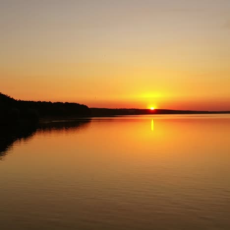 river at sunset. flight over the evening water. natural landscape of a lake at the setting sun. aerial view.