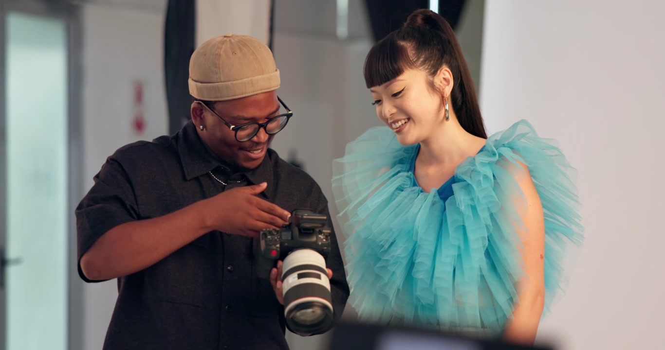 Photographer and Model Reviewing Photos on Camera in Studio