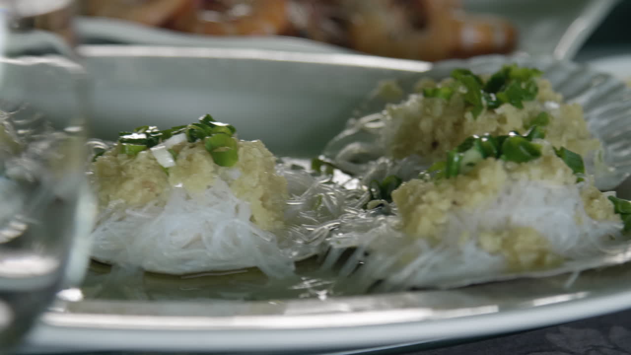Sea shells on a plate served on the table in an asian seafood restaurant