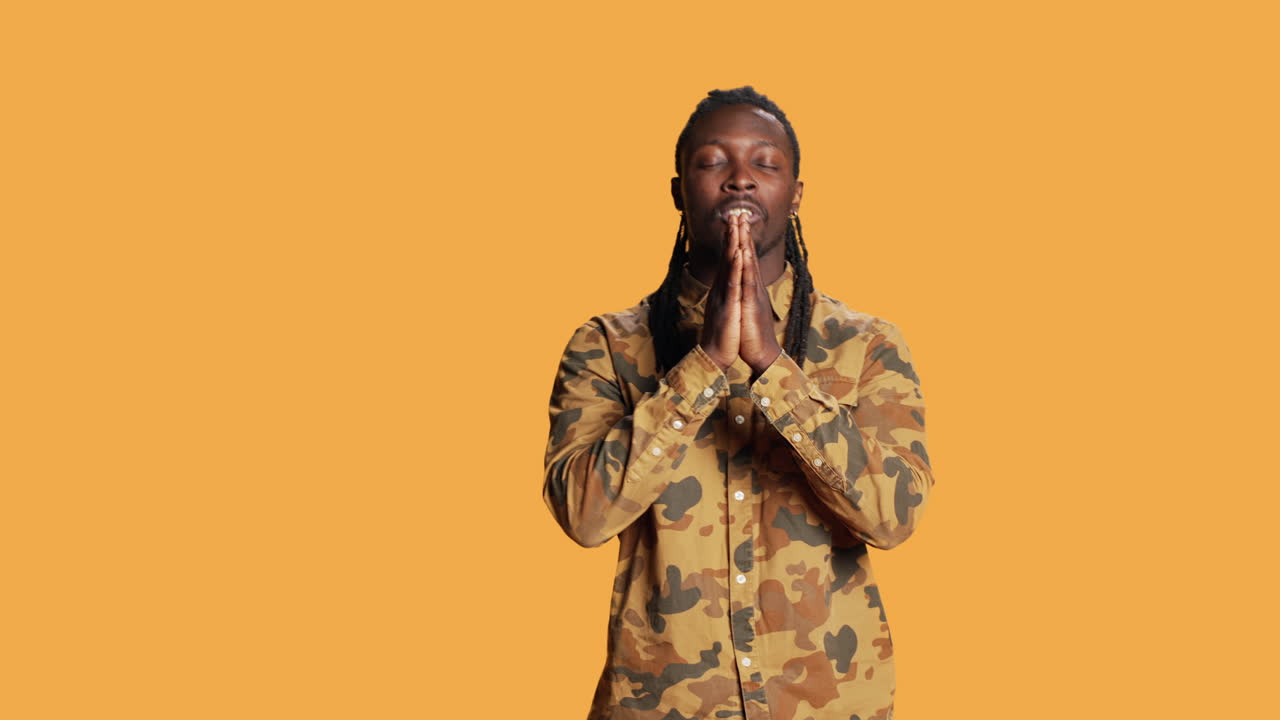 African american person praying to Jesus in studio