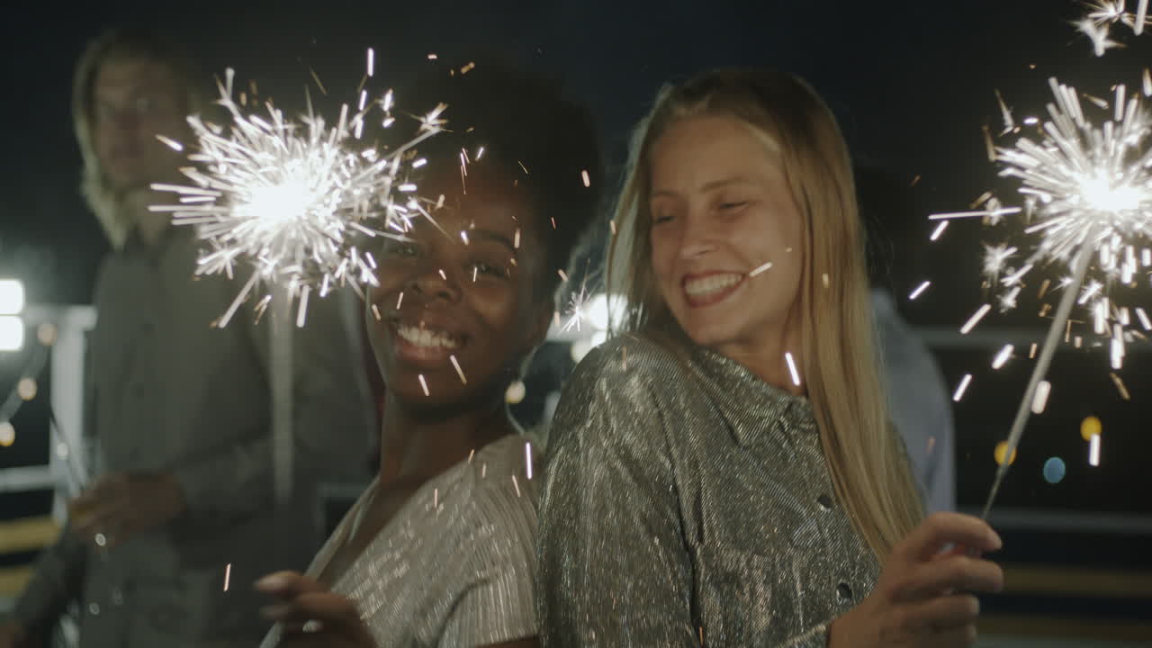 Friends Celebrating on a Rooftop at Night