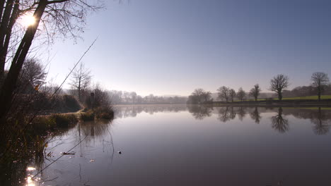 absolutely stunning wide shot of a glassy lake early in the morning