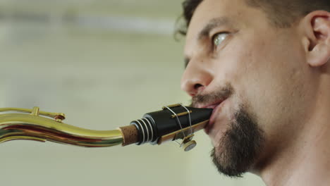 close-up of a man playing the saxophone
