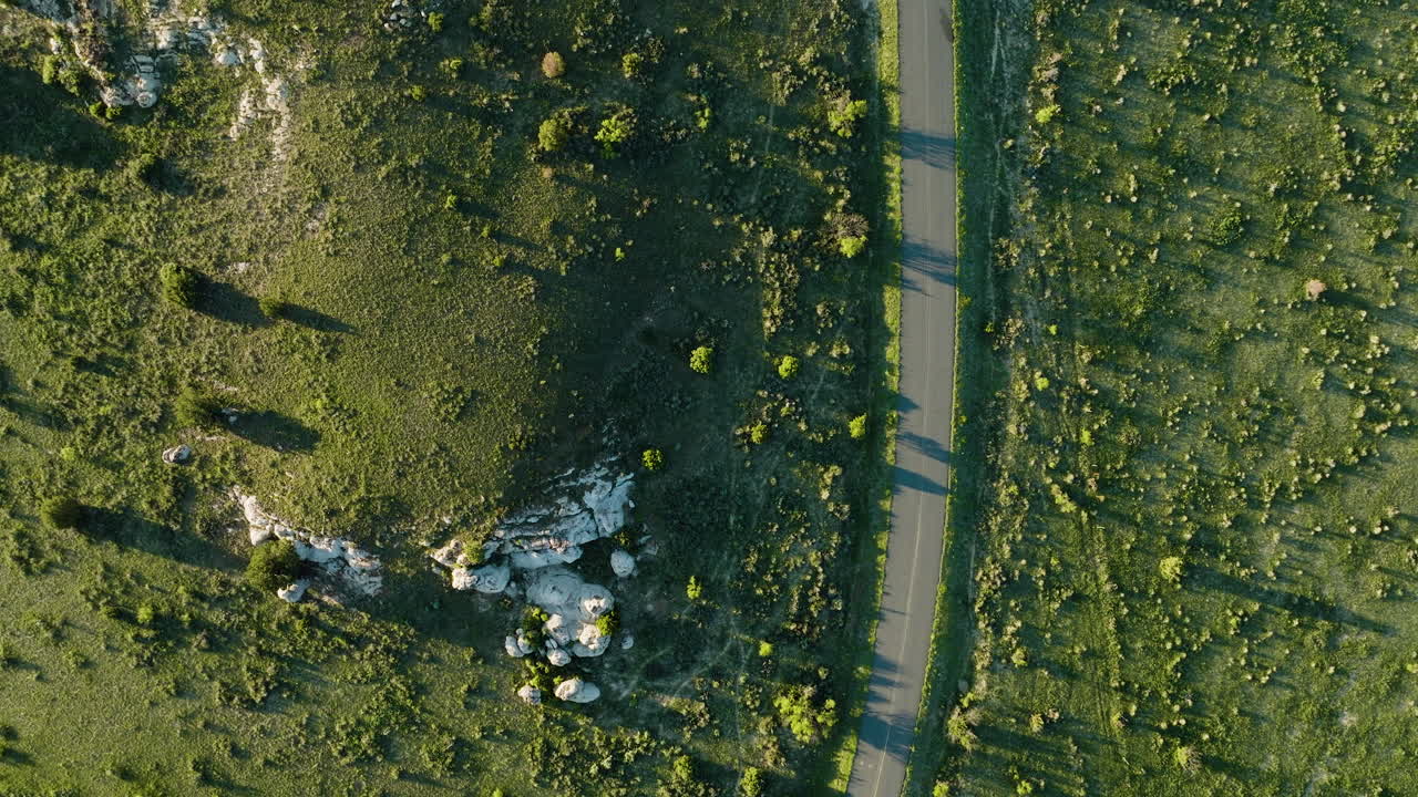 Aerial View of a Road Through a Hilly Landscape