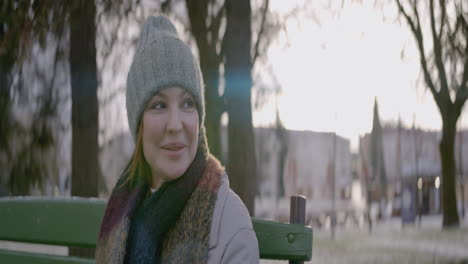 woman sitting on a bench in a park in winter