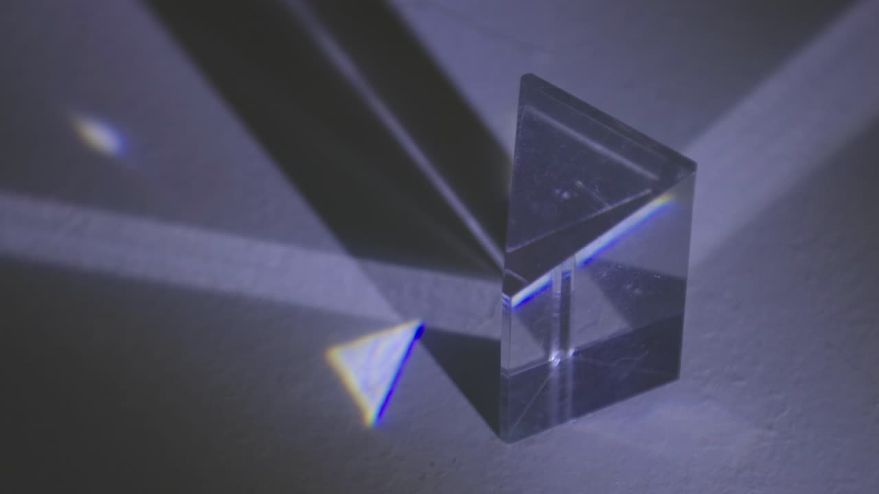 Light Slowly Brightening On A Glass Prism In The Dark - close up