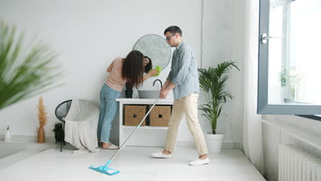 couple cleaning a room