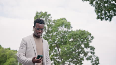 Business-phone,-city-and-walking-black-man