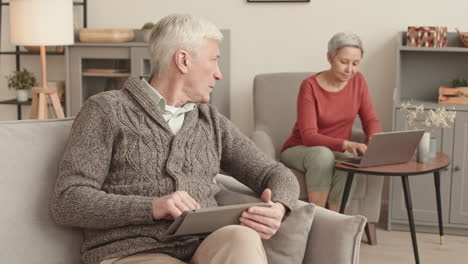 elderly couple using technology at home