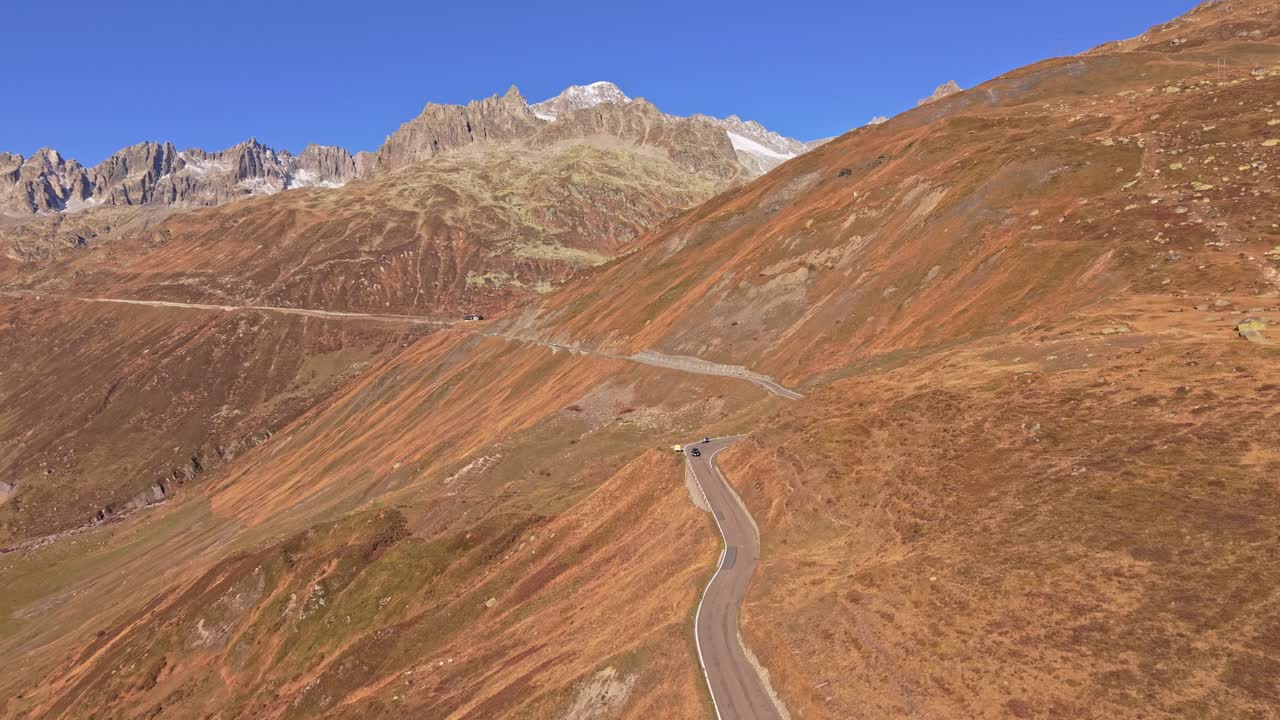 Bright alpine view of Furka Pass from above in Swiss mountain region