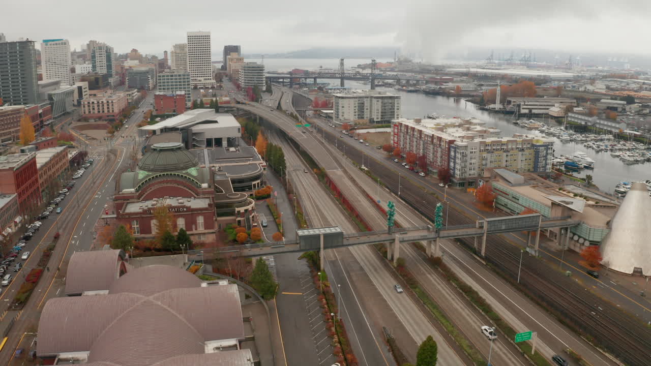 Arcing aerial shot over downtown port city on a foggy day, Tacoma, Washington