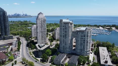 drone flying around city buildings on the lakeshore of lake ontario near downtown toronto