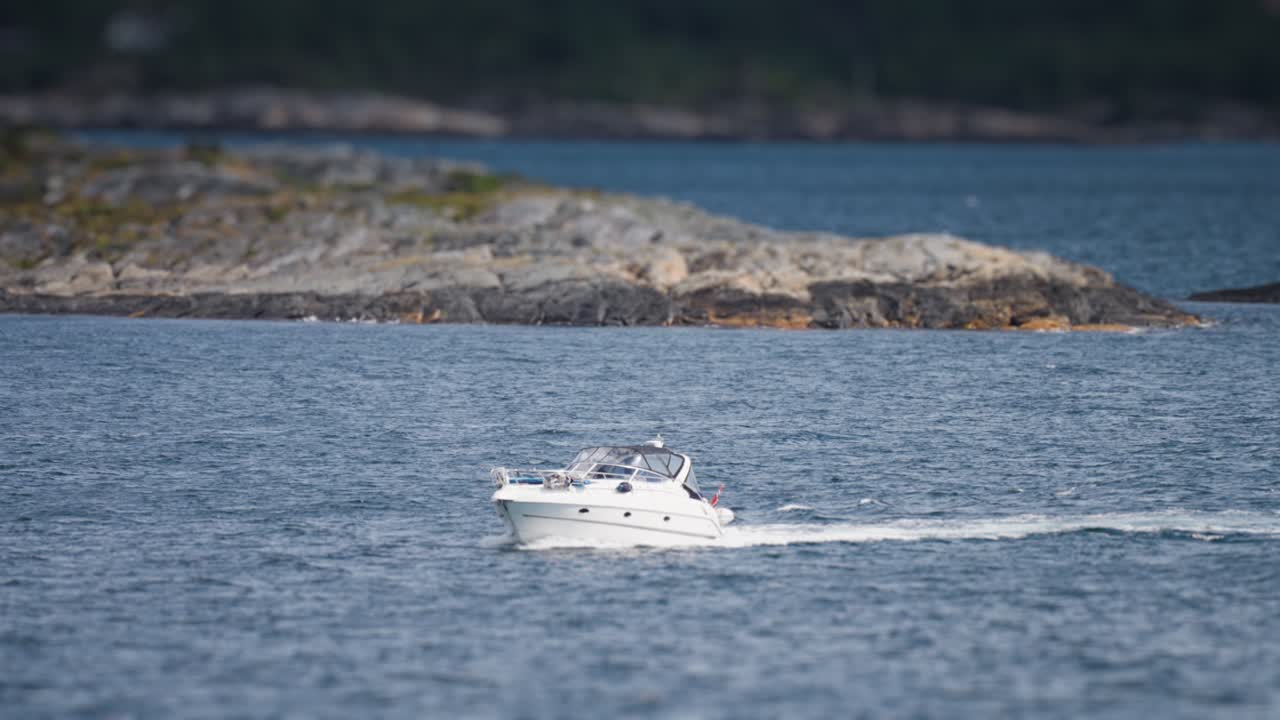 Two motorboats in the sea between the rocky islands