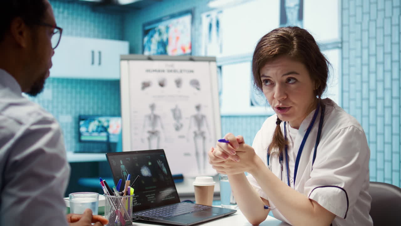 Physician meets with a patient to discuss medical results in a cabinet