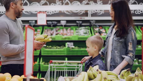 family shopping for bananas at the grocery store