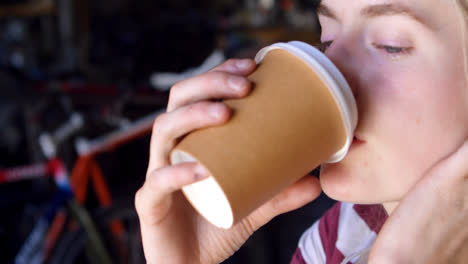 Woman-having-coffee-at-workshop-4k