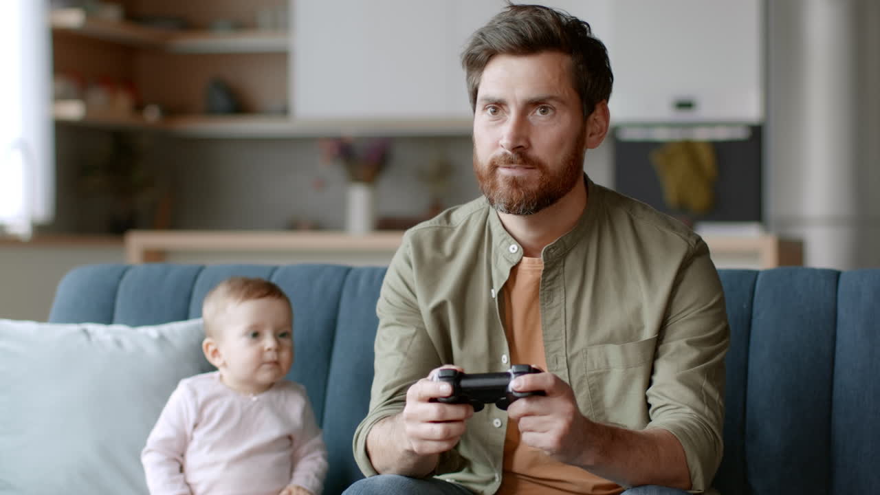 Father playing video games with baby