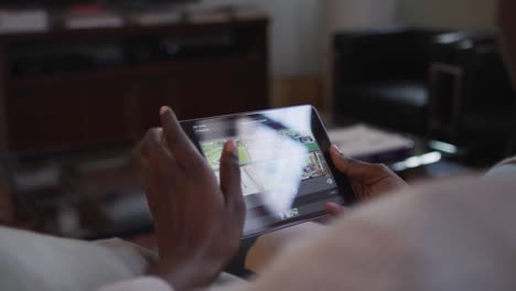 Hands-of-african-american-woman-using-smartphone-and-lying-on-sofa