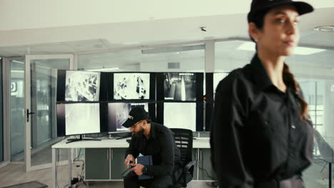 security guards monitoring security cameras in a control room