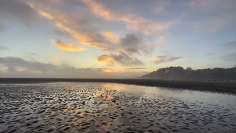 Reflections-of-the-sunset-in-the-wet-sand-of-the-Oregon-coast-beach