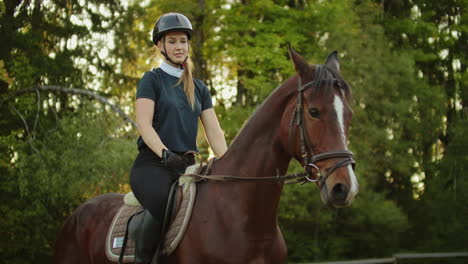 good feelings of horse riding. horsewomen is sitting on a horse and enjoys her hobby.