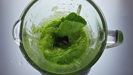 preparing green vegetables smoothie in blender close up. vitamin healthy food.