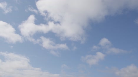 cotton clouds move over the blue skies