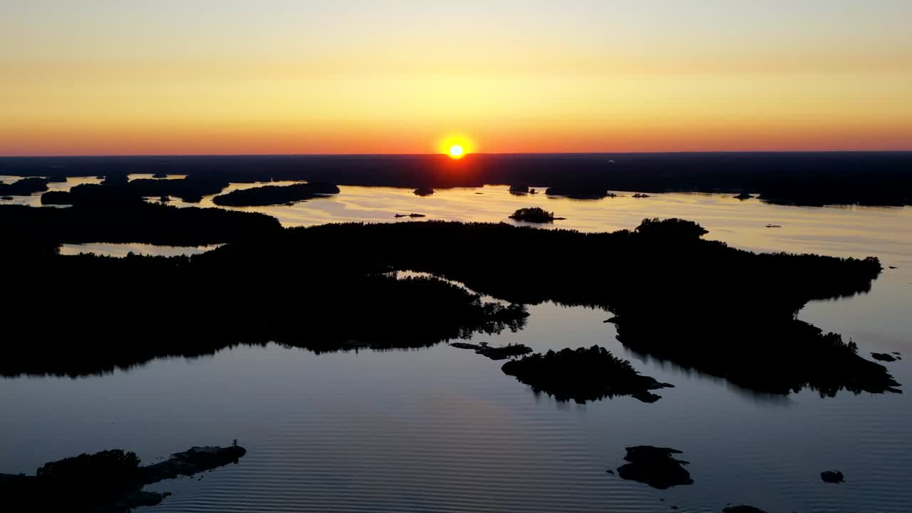 Aerial hyperlapse view over small islands, on a calm, summer evening, in the Finnish archipelago, Finland - motion time lapse, drone shot