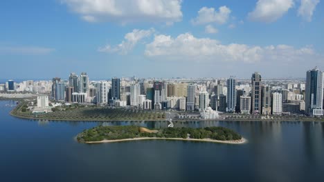 4k: sharjah from the top, aerial view of sharjah city and khalid lake, al noor mosque and island, travel tourism business in the united arab emirates