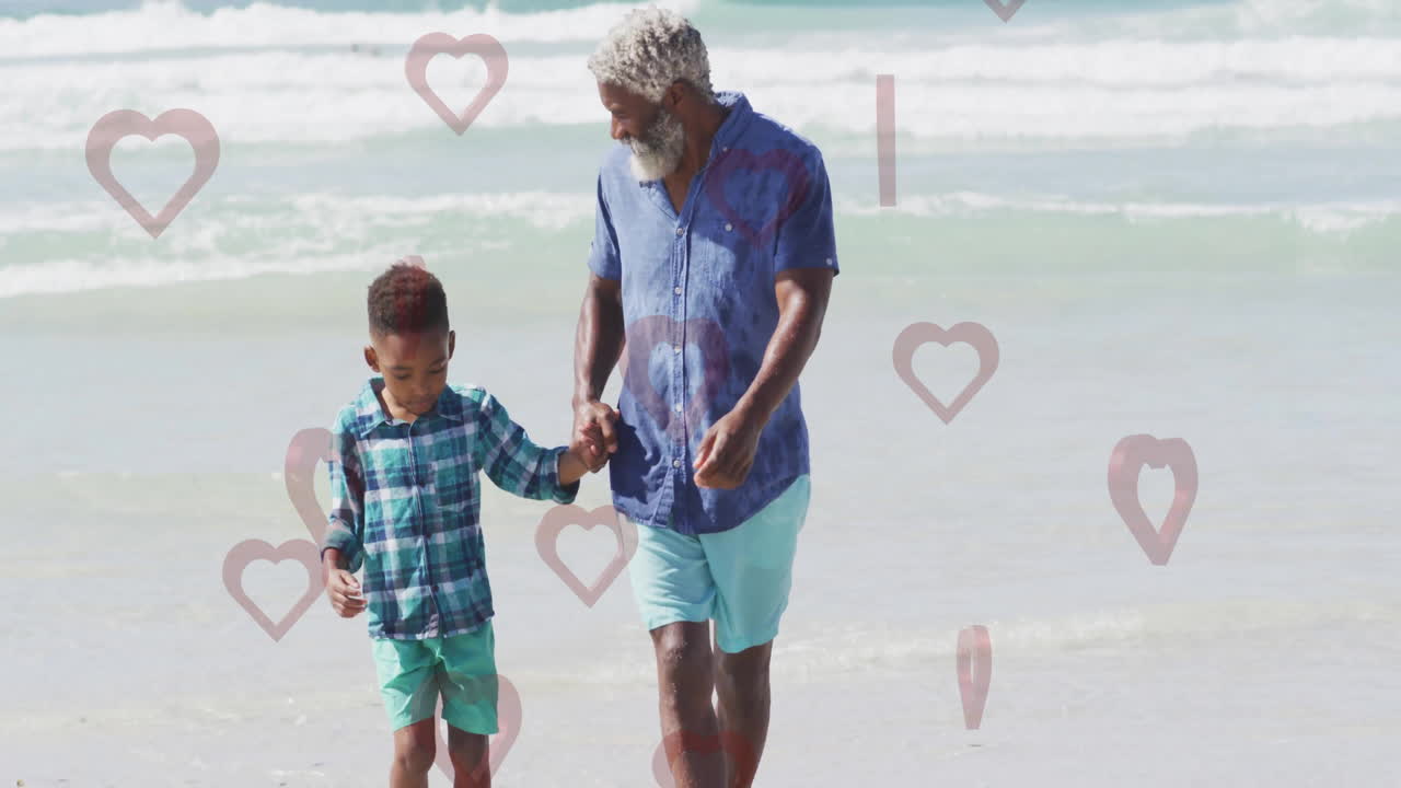 Walking on beach, elderly man and child with heart animation overlay