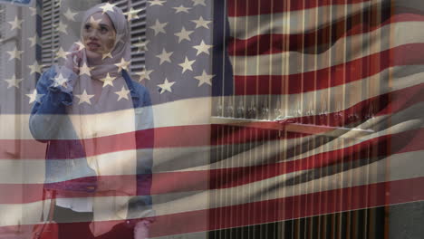 animación de la bandera estadounidense ondeando sobre una mujer en hijab caminando y hablando en su teléfono inteligente