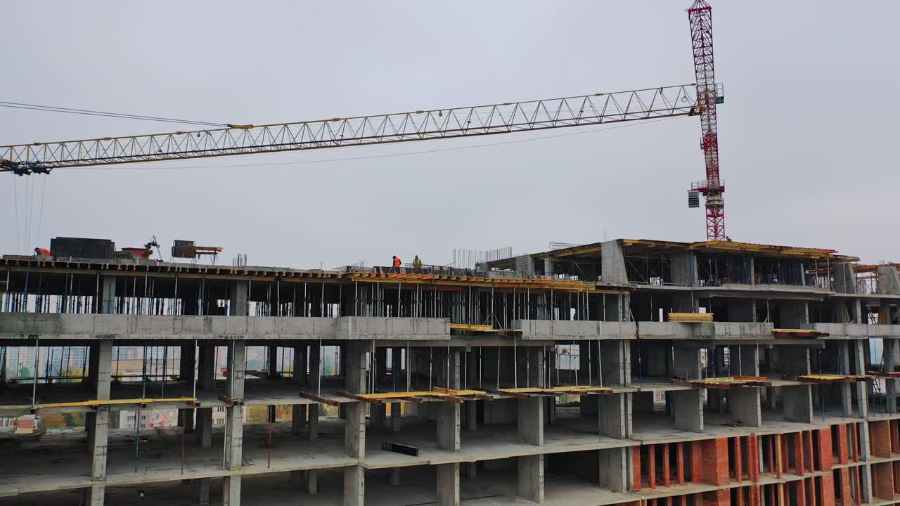 Construction site in a megacity. Video shooting with drone. New house in a residential complex. Motion camera back.