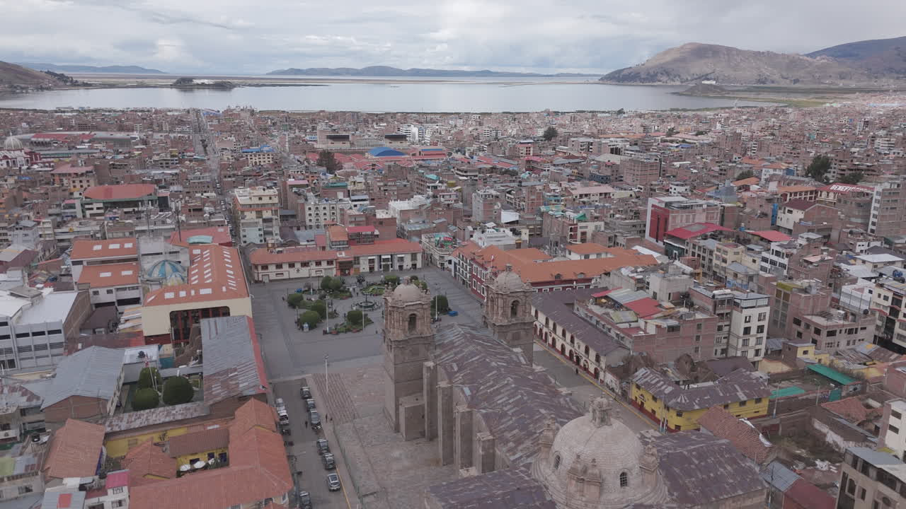 Drone shot above Plaza Mayor de Puno Peru near the church or cathedral LOG