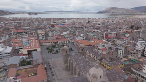 drone shot above plaza mayor de puno peru near the church or cathedral log
