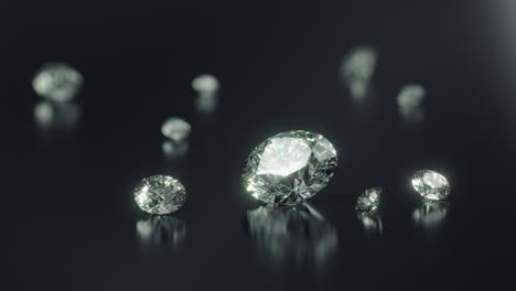 a group of different sized cut diamonds on rotating black shiny surface