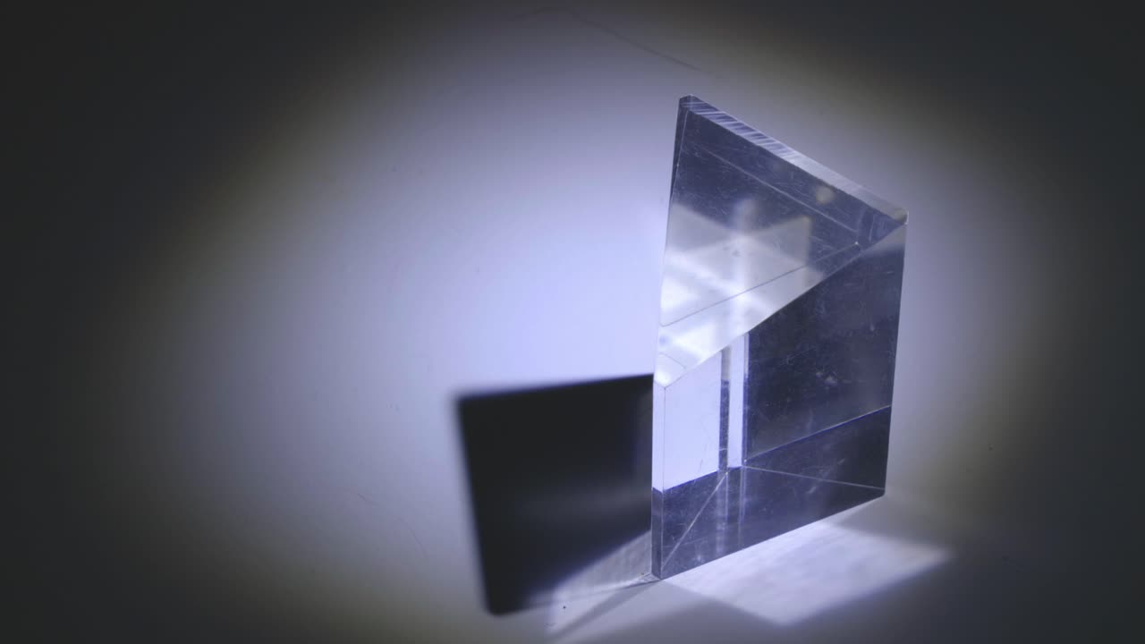 Light Passing Through A Glass Prism Bending In The Dark - close up