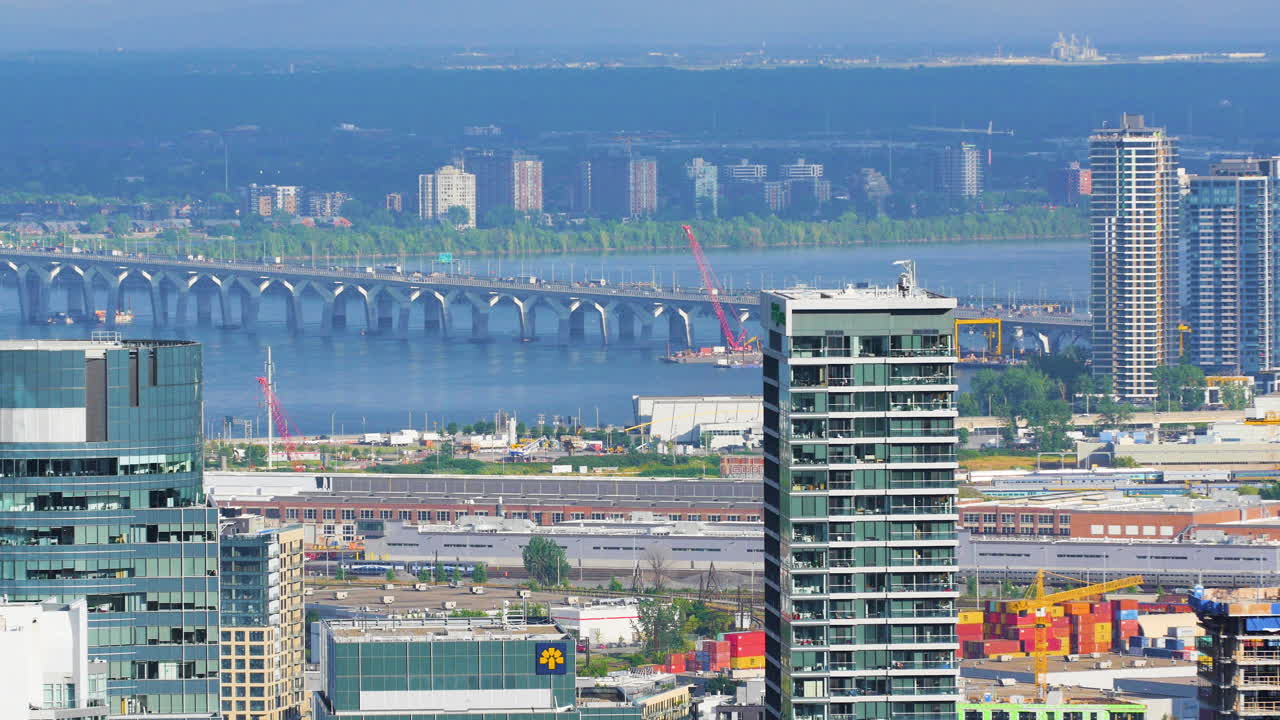 Montreal, Canada. A zoomed in shot that pulls into focus. Revealing a view over downtown Montreal. A bridge to Parc Jean Drapeau and the horizon line in the far distance. Captured in 4K